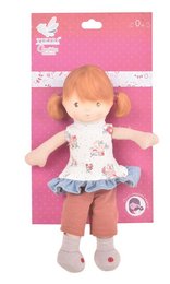 A small, plush doll with red hair and a floral dress, sitting in a woven basket with other doll accessories.