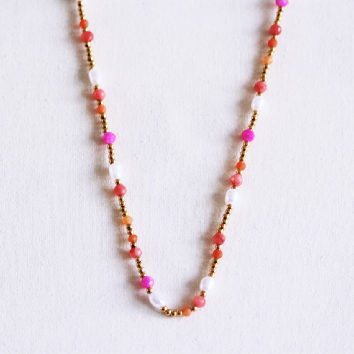 Kralenketting met parels en facetten - koraal/oranje/roze