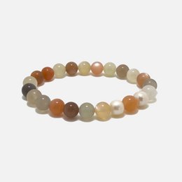 Aura moonstone bracelet with natural stone beads in various sizes, featuring a neutral color palette of browns, tans, and whites.