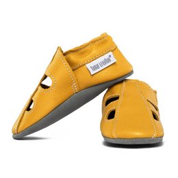  Leather summer slippers in a vibrant yellow color, featuring a simple and minimalist design. The slippers have a comfortable and flexible sole, making them suitable for indoor and outdoor wear.