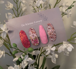 Set of 46 colorful hair clips for kids, featuring glitter, sequins, and textured designs in various shades of pink.