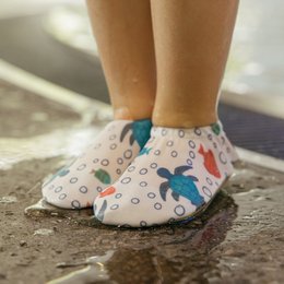 Colorful turtle and fish print kids water shoes, blue pink white, lightweight beach slippers for children.