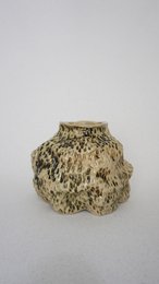 A handmade, matte gray vase with a simple, cylindrical shape.