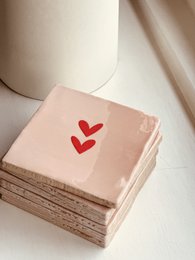  Peach-colored poster with red heart shapes, suitable for decorative or romantic purposes.