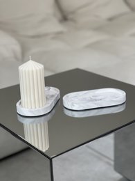 Oval white marble tray with a white candle holder.