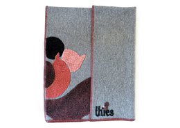 Grey wool blanket with abstract squirrel design in coral, black, and burgundy tones.