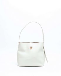 Camel-colored leather bucket bag with a simple, minimalist design and a single shoulder strap.
