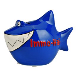 A blue ceramic storage box in the shape of a shark, with the text "Immobilienhai" printed on it. The dimensions of the box are 13x11x7.5cm.