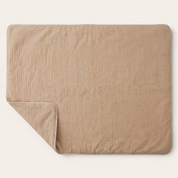  Nude-colored, rolled playmat with a soft, textured surface and a tied bow detail.