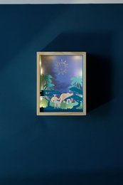Decorative night light frame with a whimsical forest scene featuring a lion and other animals, suitable for a child's room.
