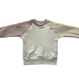 A cozy, colorblock sweater for kids in a neutral, light gray color. The sweater has a raglan sleeve design and a relaxed, comfortable fit.