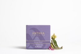Organic energy blend loose leaf tea in a purple box with a decorative green frog figurine.