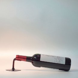 Decorative red wine bottle holder with a sleek, modern design. Made of high-quality materials for a stylish and functional wine accessory.