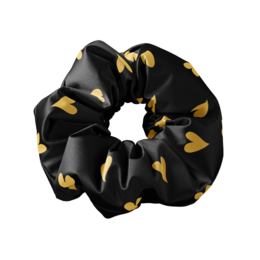 Black and gold heart-patterned scrunchie. Made of soft, stretchy fabric. Ideal for styling hair and adding a touch of style.