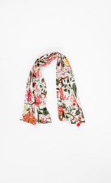 Floral patterned cotton scarf in white, pink, and green tones. Features a whimsical, fantasy-inspired design with various flowers, leaves, and abstract shapes.