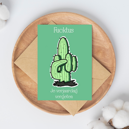 A green cactus illustration with the text "Ricktus je verjaardags vergeten" on a green background.