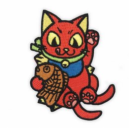 Colorful embroidered patch featuring a cute red cat-like character holding a fish. The patch has a vibrant, whimsical design with details like the cat's large eyes and paws. This playful and eye-catching patch would be a fun addition to clothing, bags, or other items.