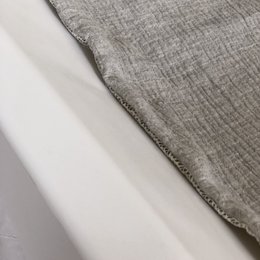 Light grey changing mat made of soft, textured fabric.