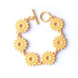 Flower chain bracelet with yellow dahlia-shaped charms in a citrus color.