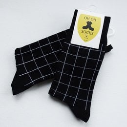Black and white striped socks with a yellow label.