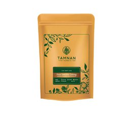 Premium loose oolong tea in a yellow and green package with a leaf design. The tea leaves are dark brown in color.