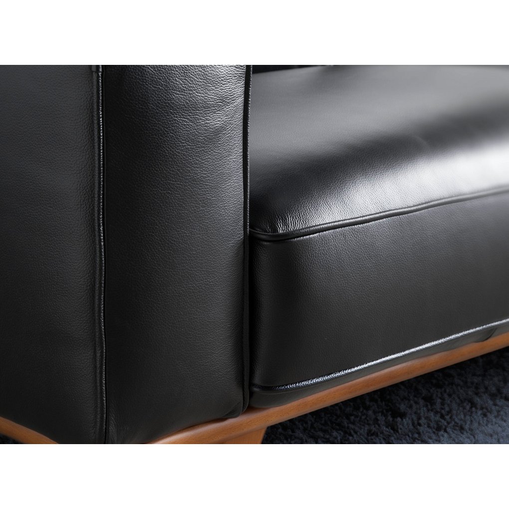 Armchair upholstered in leather and Walnut wood legs
