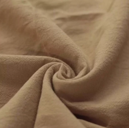  Soft, washed cotton crib sheet in a warm, earthy cacao color.