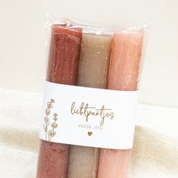 Set of 3 tall, round candles in shades of red and pink. Ideal for creating a warm, cozy ambiance in any room.