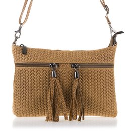 Tan woven shoulder bag with tassel accents, made of genuine leather suede. Features a herringbone pattern and engraved detailing.
