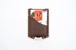 Brown leather wallet with stitched edges and card slots.