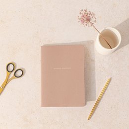 A5 size organic notebook with grid or lined pages, made of beige-colored material.