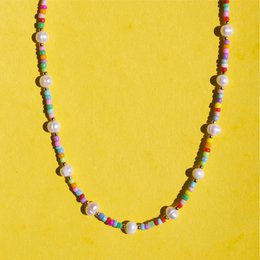 A colorful beaded necklace with a mix of pearl and multicolored beads.