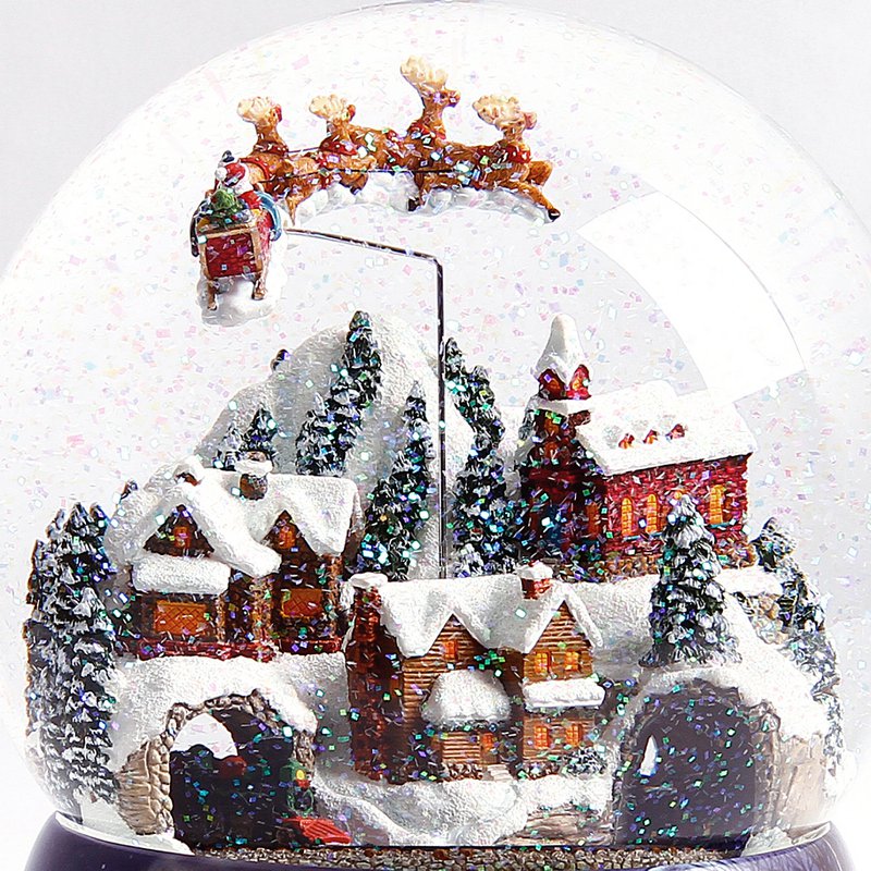 Kæmpe musikalsk sneglob "The Christmas Village" med et lille tog, julemandens slæde trukket af hans rensdyr og blandingen