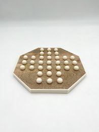  Octagonal wooden board game with white pegs, suitable for strategic gameplay.