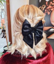 Black velvet hair bow with a textured pattern, suitable for hair clips or accessories.