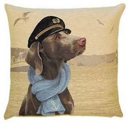 Decorative pillow cover featuring a Weimaraner dog wearing a captain's hat and scarf against a desert landscape background.