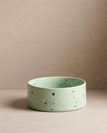 Two round, green pet food bowls with a speckled pattern. The bowls are 14cm in diameter and come as a set of 2.