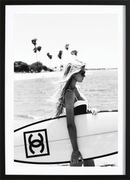 Chanel surfboard poster, featuring a woman holding a surfboard on the beach. Available in various sizes.