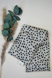 Cream cotton heating pad with black dots pattern, organic spelled fill, rectangular shape, wellness product.