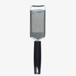  Stainless steel multifunctional grater with a comfortable grip handle, suitable for grating various ingredients.