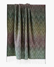 Cozy yellow throw blanket with fringe detail, made of soft, high-quality material for a comfortable and stylish addition to any living space.