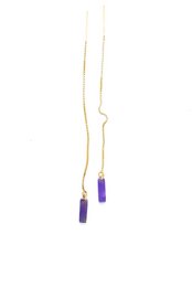 Gold-toned drop earrings with amethyst-colored pendants.