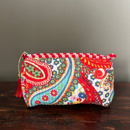 Vibrant red cotton toiletry pouch with paisley pattern, available in medium, large, and small sizes.