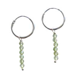 Elegant hoop earrings with peridot beads, available in gold filled or 925 sterling silver. The round hoops and dangling peridot stones create a chic, minimalist look.