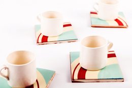 Set of 4 round coasters with a retro-inspired geometric design in red, white, and mint green.