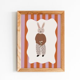 A framed poster featuring a rabbit-like character with a heart-shaped body, set against a striped background. The poster appears to be designed for a nursery or child's room.