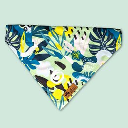  Colorful tropical print dog bandana with vibrant blue, yellow, and green leaves and patterns. Made of soft, breathable fabric for pet comfort.