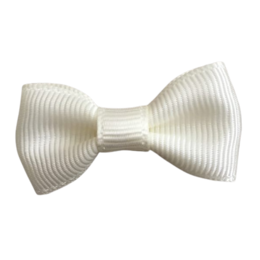 Cream-colored bow tie hair clip for babies, made of soft, ribbed material.