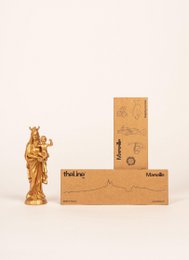 A miniature relief image depicting the skyline of Marseille, France. The image features a wooden frame and a small figurine, creating a unique and artistic display.