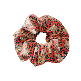 A red and orange leopard print scrunchie with a textured fabric.